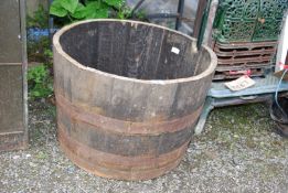 A half whisky barrel planter,