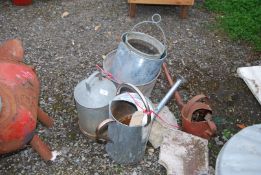 A galvanised watering can and buckets.