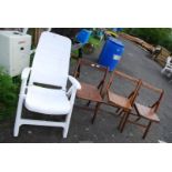 Three folding wooden chairs and a white plastic garden seat.