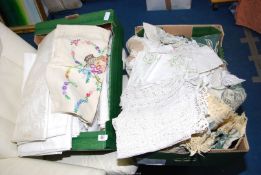Two boxes of linen, tablecloths etc.