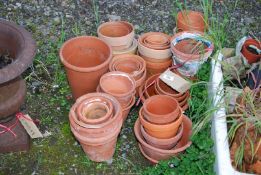 A quantity of terracotta pots in various sizes.