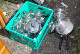 A quantity of stainless steel saucepans.