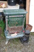 A multi purpose green cast enamel Stove with pipe work.