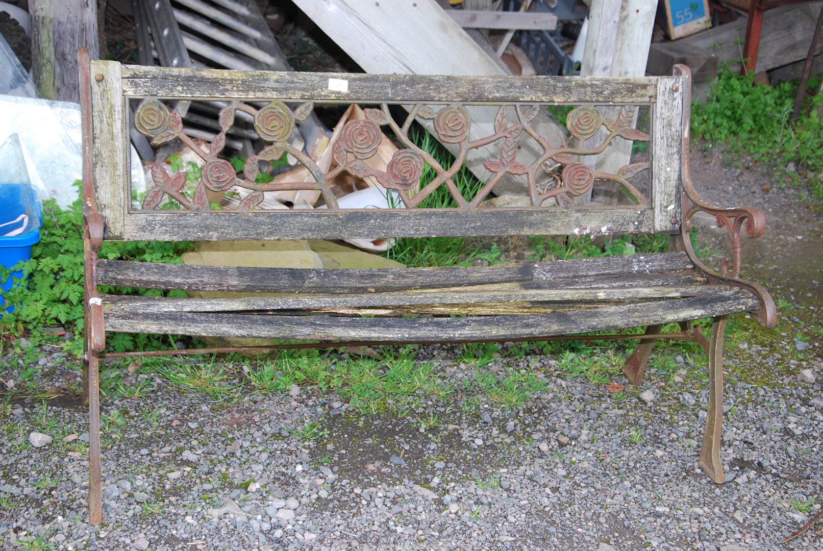 A garden bench with cast ends and leaf design back, for restoration, 50'' long x 29'' high.