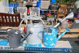 Three watering cans.