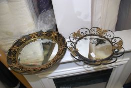 Two mirrors with metal surround.