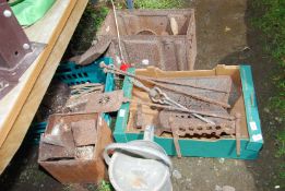 A quantity of fire irons, watering can, old biscuit tin, tools, boot scraper, etc.