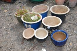Eight glazed terracotta pots.