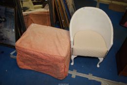 A Lloyd Loom style chair and a large pouffe.