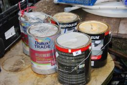 Tins of Floor covering and masonry paint.