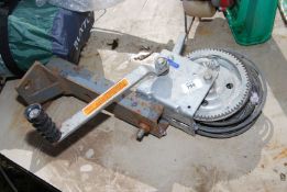 A trailer hand winch, fixed to a bracket.