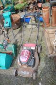 A Honda lawn mower, (engine turns at time of lotting), no grass box.