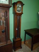 A Westminster chiming Grandmother clock, with presentation plaque.