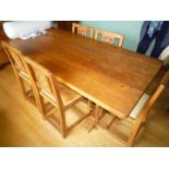 A Robert Thompson "Mouseman" Oak Dining Table standing on square stop-chamfered supports with