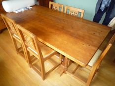 A Robert Thompson "Mouseman" Oak Dining Table standing on square stop-chamfered supports with