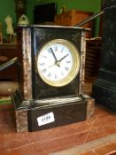 A small marble and slate Mantle Clock, white enamel face with quartz mechanism,