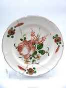 A Strasbourg Hannong type plate painted flowers 18th century, extensive repairs, 9" diameter.