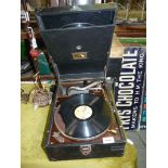 A 'His Masters voice' windup Gramophone and records (one record a/f).