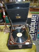 A 'His Masters voice' windup Gramophone and records (one record a/f).