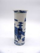 An Oriental sleeve vase having a white ground with scenes of a vase, table and footstool in blue,