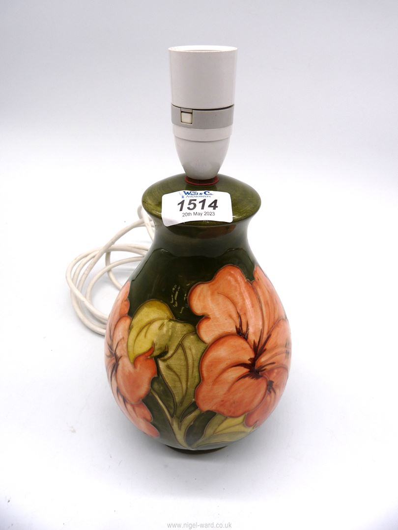 A Moorcroft table lamp in Hibiscus pattern.