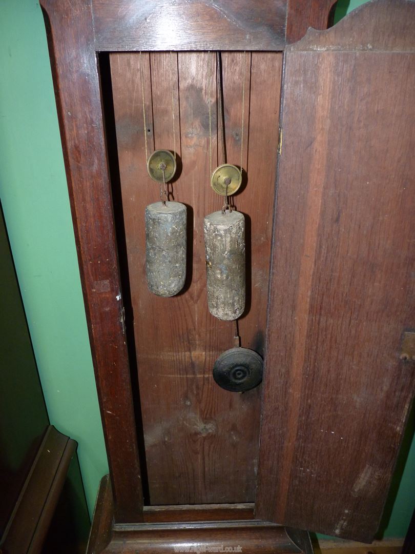 A cross-banded Oak cased Longcase Clock having a painted face with Roman hour numerals and Arabic