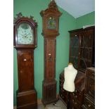 An unusually slender Oak cased long-case Clock, the case decorated in relief with bows and swags,