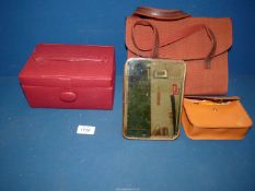 A box of leather and fabric items including vanity case, mirror, bag and shoe shine kit.
