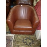 A contemporary brown hide upholstered Tub Chair in very good order.