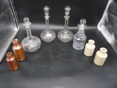 Four Victorian decanters and four small Victorian stoneware jars.