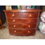 A circa 1900 Mahogany/Satinwood bow fronted Chest of three long and two short Drawers with turned