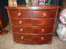 A circa 1900 Mahogany/Satinwood bow fronted Chest of three long and two short Drawers with turned