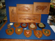 A quantity of treen fish plaques and naval shields including; H.M.S Gossamer, Illustrious, etc.