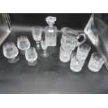 A quantity of glasses to include; whisky, brandy, wine, etc, plus a water jug and decanter.