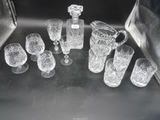 A quantity of glasses to include; whisky, brandy, wine, etc, plus a water jug and decanter.