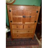 A Robert Thompson "Mouseman" panelled Oak Tallboy the upper cupboard with an opposing pair of