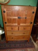 A Robert Thompson "Mouseman" panelled Oak Tallboy the upper cupboard with an opposing pair of