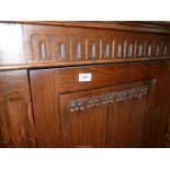 A contemporary Oak wardrobe/hall cloaks Cupboard having canted corners and a linen fold panel to