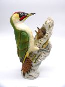 A limited edition figure of a Woodpecker feeding young in tree trunk, no.