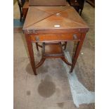 An Edwardian Mahogany/Walnut Envelope Table opening to reveal a card table lined with green baize