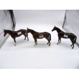 Three china horses including; two Bay Beswick (one a/f - legs broken) and a Royal Doulton Bay horse.