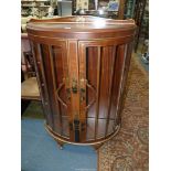 A bow fronted Display Cabinet having chinoiserie decoration and raised on brief cabriole legs,