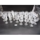 A quantity of sherry and port glasses with a leaf and flower design including twenty port glasses