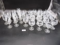 A quantity of sherry and port glasses with a leaf and flower design including twenty port glasses