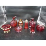 A quantity of cranberry glass comprising of jugs, sugar sifter,