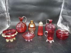 A quantity of cranberry glass comprising of jugs, sugar sifter,