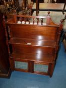 An Edwardian Mahogany wall hanging Shelf Unit having turned supports and spindles to the pediments,