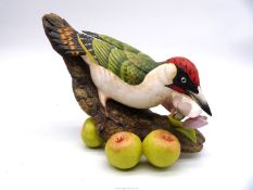 A limited edition figure of a Woodpecker on branch with apple blossom and three cider apples, no.