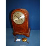 A dome shape Mantle clock, with key and pendulum, 7" wide x 11 1/4" tall.