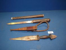 A hand carved shot Baton with concealed knife blade and an African dagger.